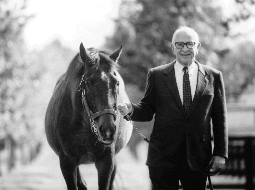 John R. Gaines, pictured in November 1988 on his farm with an unidentified thoroughbred